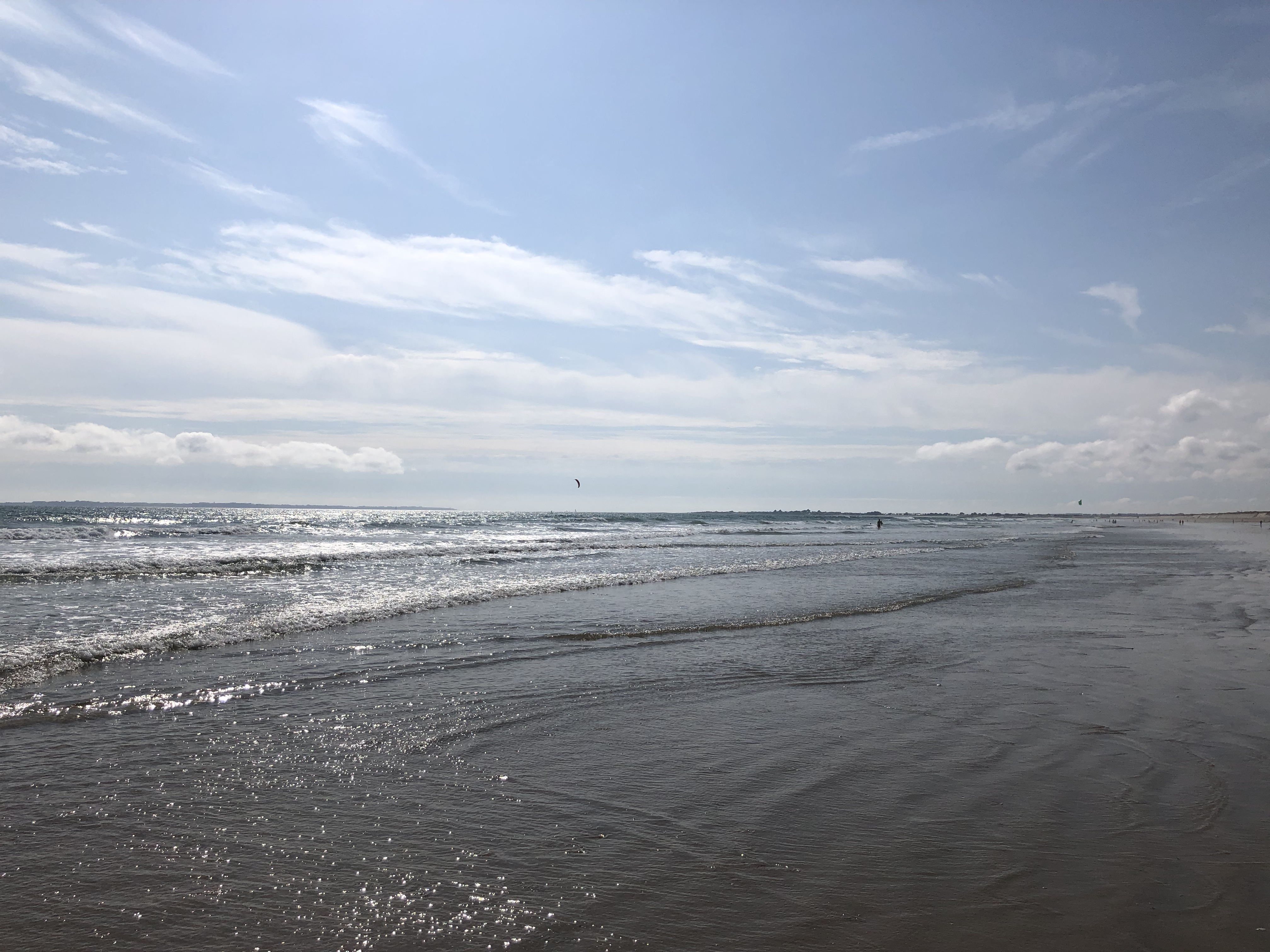 Gently rolling surf onto a sandy beach