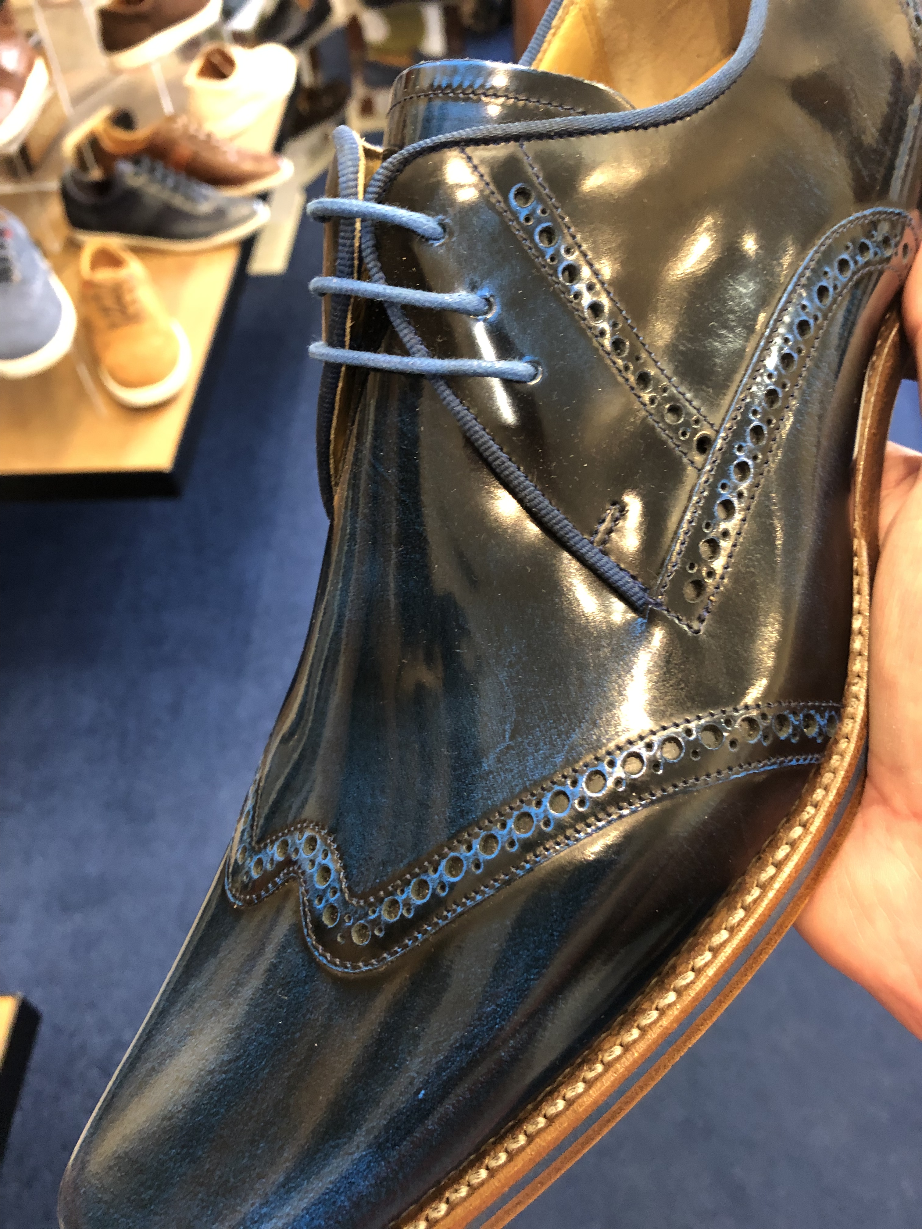 Blue leather shoe from side view.